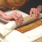 Preparing cake into a roll