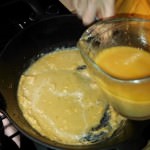 Whisking to smooth roux and juices to thicken