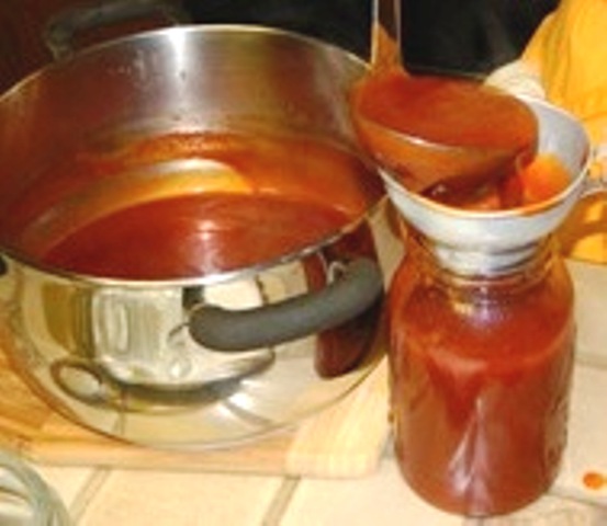 Putting Maple Mesquite Bar-B-Que Sauce into canning jar.