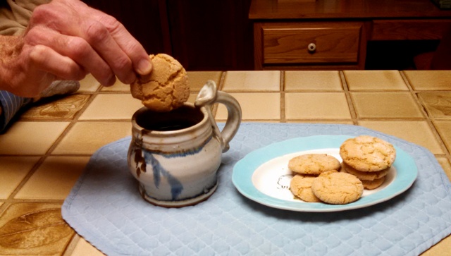 The Dipping Cookie into cup of coffee